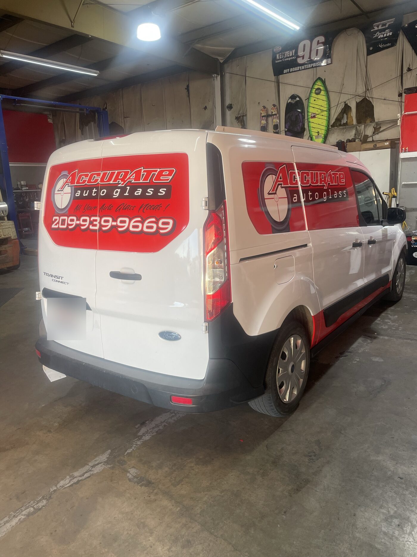 The Accurate Auto Glass van, lettered with the shop logo and phone number