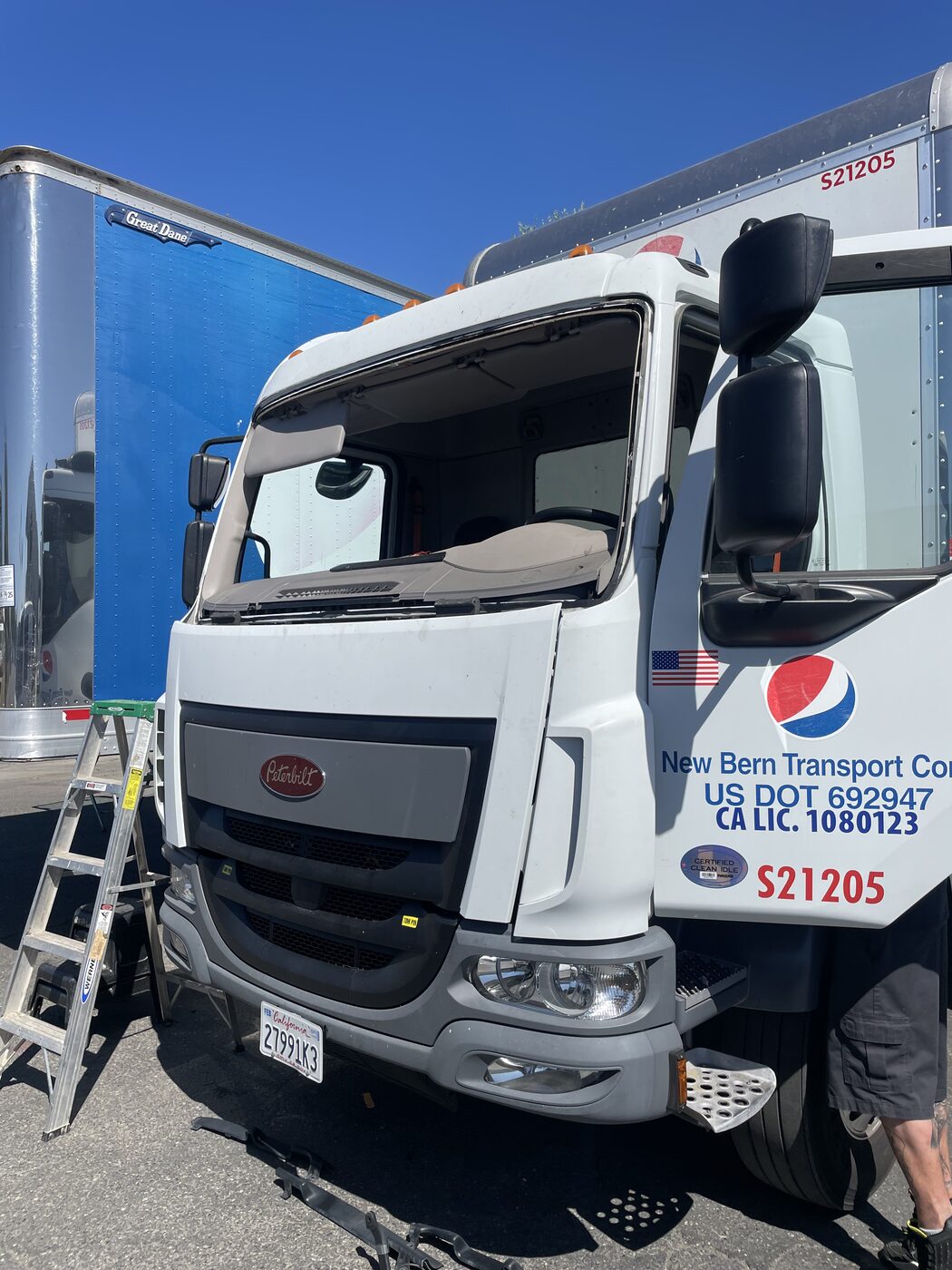 A box truck with the windshield out, ready for new glass