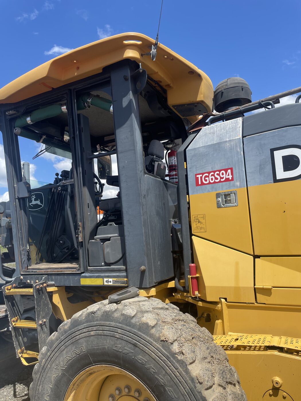 John Deere grader cab with the glass out