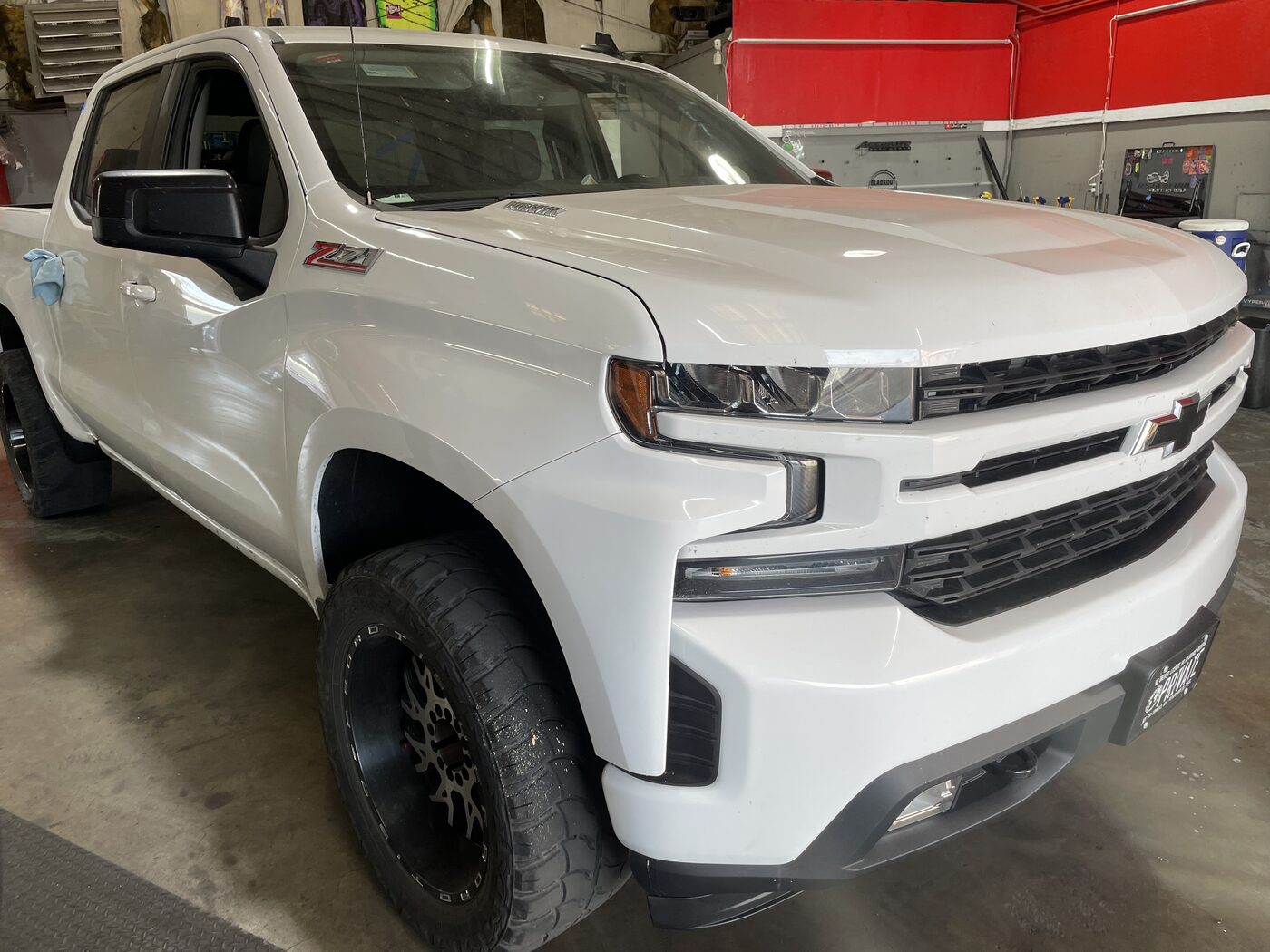 A white Chevy Silverado in the shop